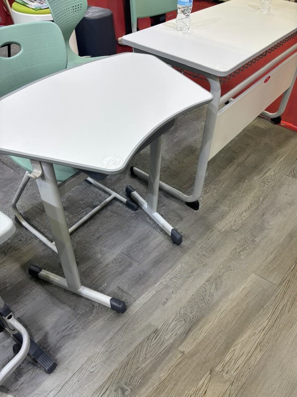 Contoured single student desk with a curved grey top — interior concept